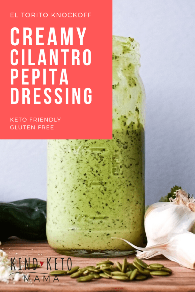 Jar of creamy cilantro dressing surrounded by pumpkin seeds, garlic, peppers, cilantro and grated cheese.
